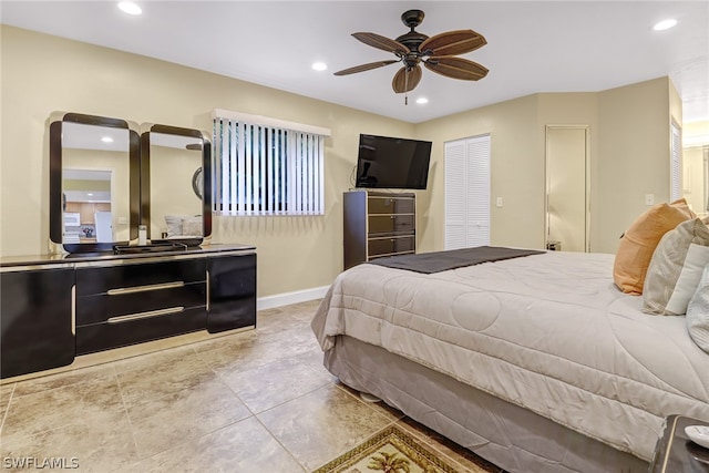 bedroom featuring ceiling fan, a closet, and light tile flooring