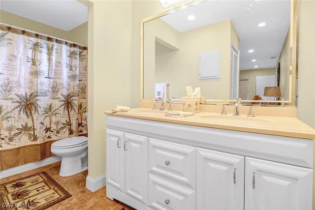 bathroom featuring toilet, double vanity, a sink, and a shower with shower curtain
