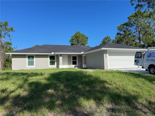 ranch-style home featuring a garage and a front lawn