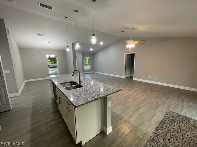 kitchen featuring hardwood / wood-style flooring, sink, vaulted ceiling, and a center island with sink