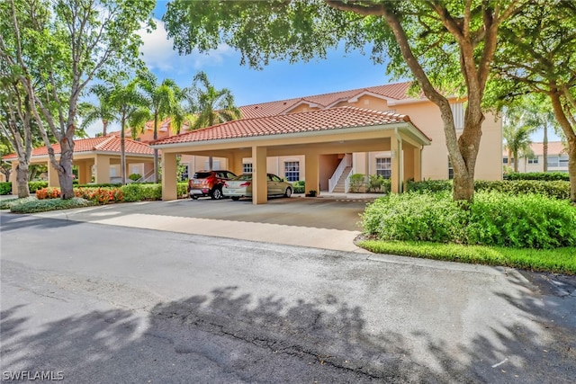 mediterranean / spanish house with a carport