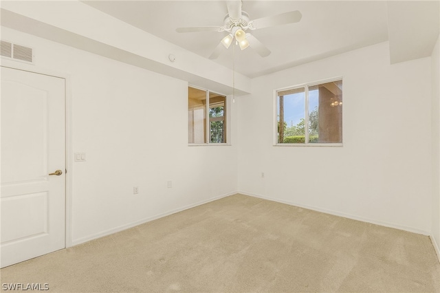 unfurnished room featuring light carpet and ceiling fan