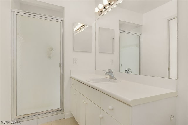 bathroom featuring vanity and an enclosed shower