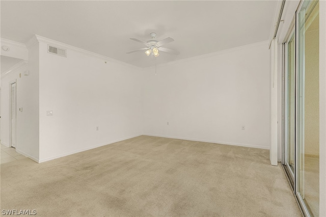 carpeted spare room featuring ceiling fan and ornamental molding