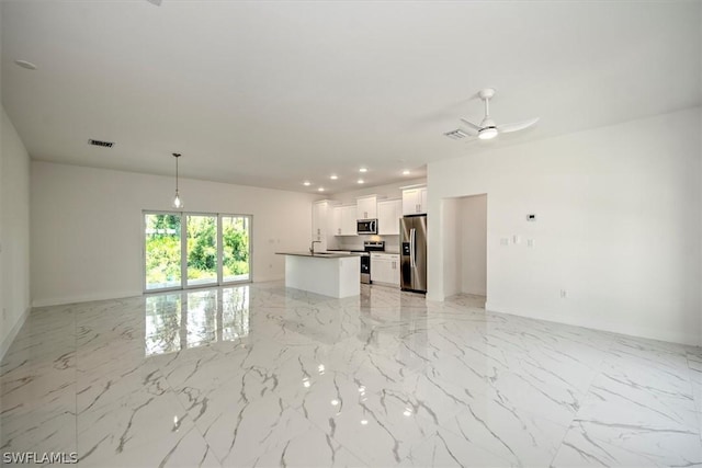 unfurnished living room featuring ceiling fan