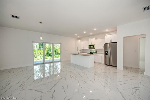 kitchen with stainless steel appliances, sink, white cabinets, hanging light fixtures, and a kitchen island with sink