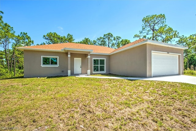 ranch-style house featuring a garage and a front lawn