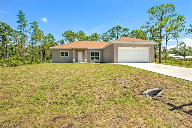 view of front of property with a front lawn and a garage