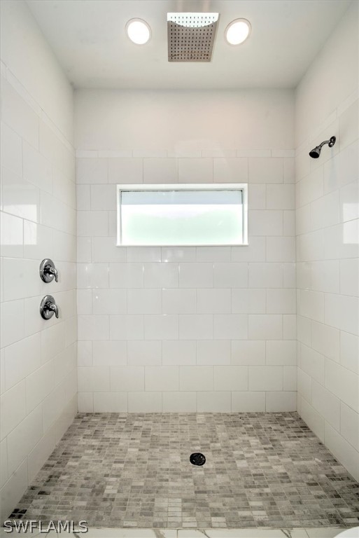 bathroom with tiled shower