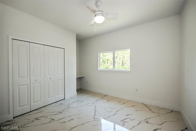 unfurnished bedroom with ceiling fan and a closet