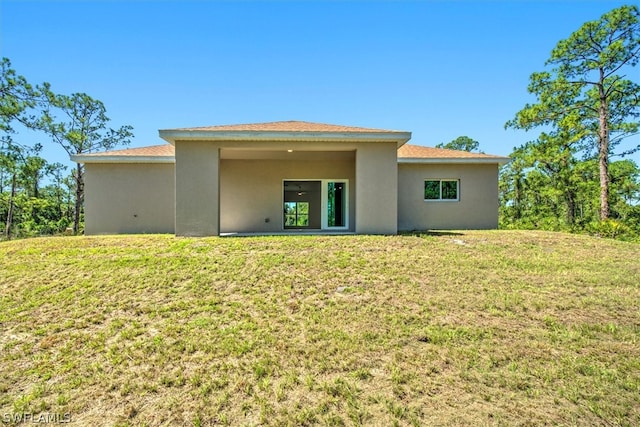 rear view of house with a lawn