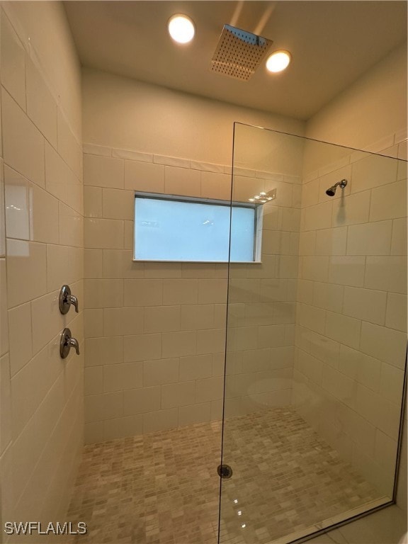 bathroom with tiled shower