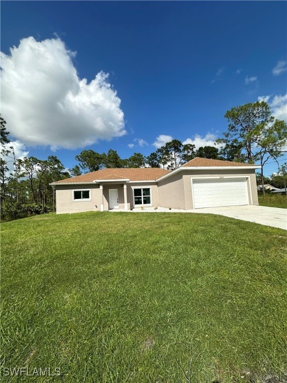 ranch-style house featuring a front yard and a garage