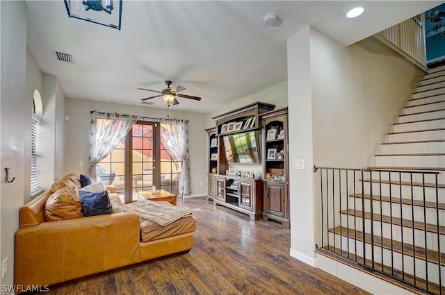 living room featuring ceiling fan and dark hardwood / wood-style flooring