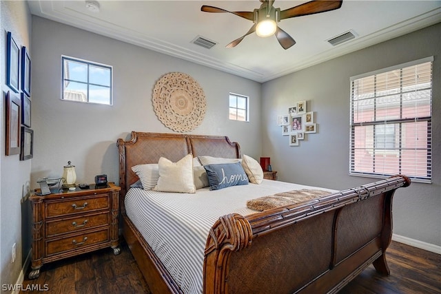 bedroom featuring ceiling fan, dark wood-type flooring, and multiple windows