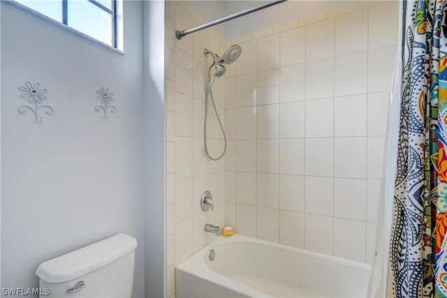 bathroom featuring toilet and shower / bath combo with shower curtain