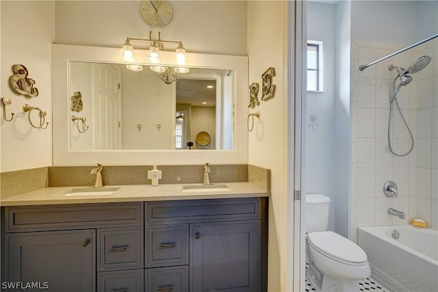 full bathroom featuring vanity, toilet, and tiled shower / bath