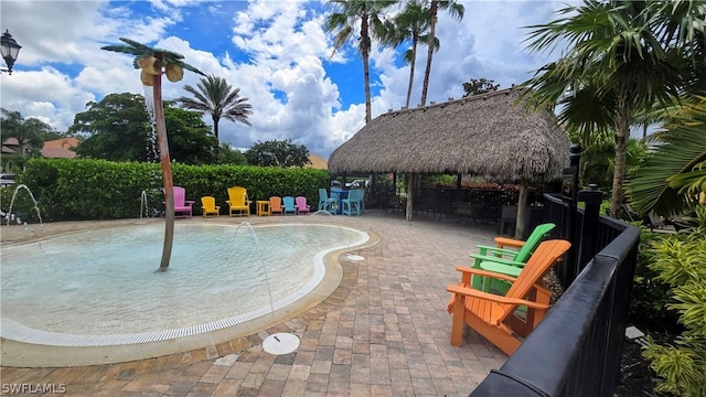 view of pool featuring a gazebo, a patio area, and pool water feature