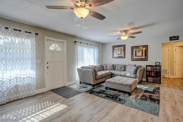 living room featuring hardwood / wood-style flooring and ceiling fan