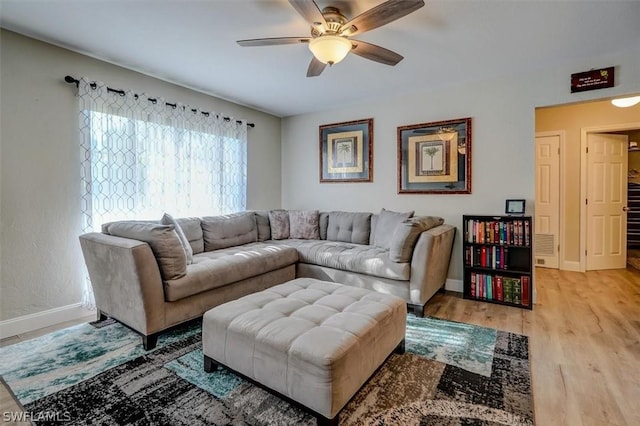 living room with ceiling fan and wood-type flooring