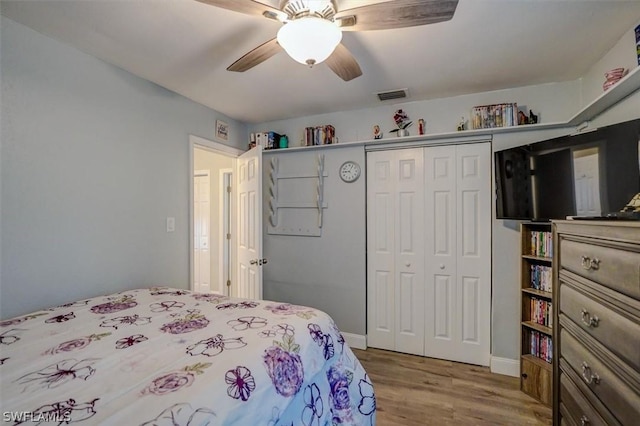 bedroom featuring wood-type flooring, a closet, and ceiling fan