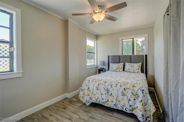 bedroom with light wood-type flooring, ceiling fan, and crown molding