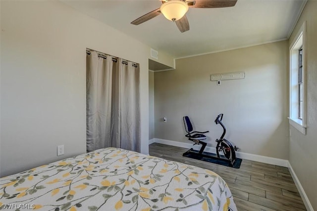 bedroom with ceiling fan and hardwood / wood-style flooring