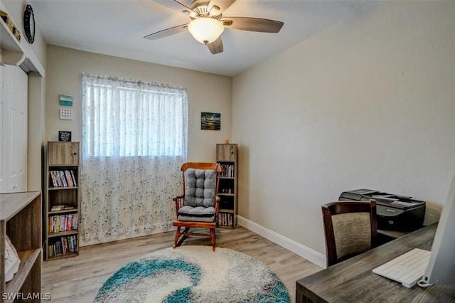 home office with ceiling fan and light wood-type flooring