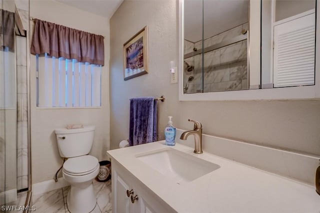 bathroom with vanity, toilet, and an enclosed shower