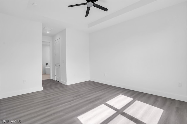 spare room featuring ceiling fan and dark hardwood / wood-style floors