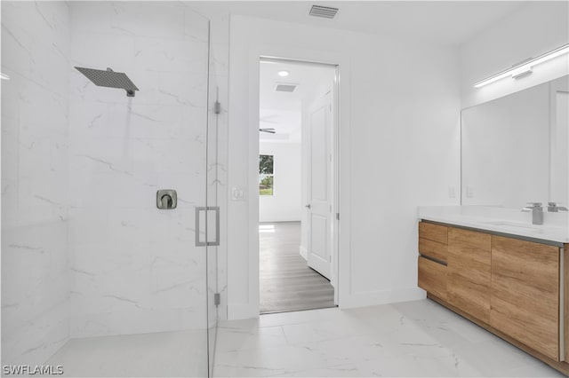 bathroom featuring wood-type flooring, vanity, and a shower with door