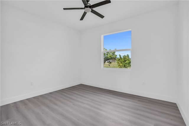 spare room with hardwood / wood-style floors and ceiling fan