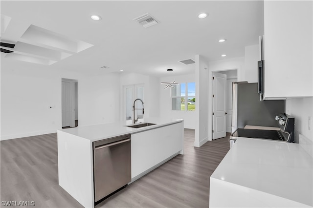 kitchen featuring sink, white cabinets, stainless steel appliances, and a center island with sink