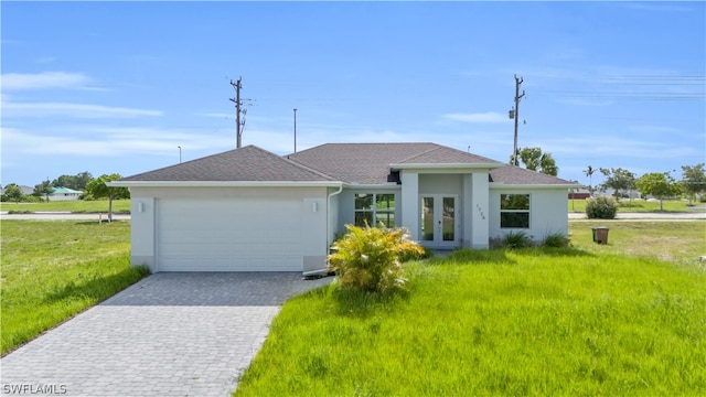 view of front of property with a garage, a front yard, and french doors