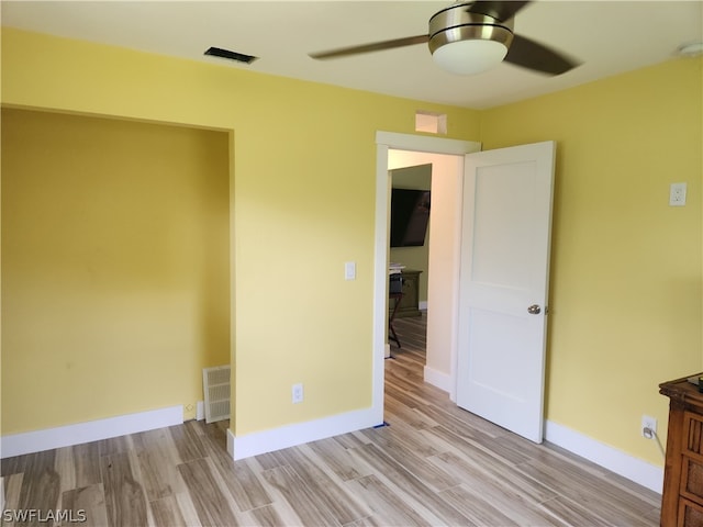 spare room featuring ceiling fan and light wood-type flooring