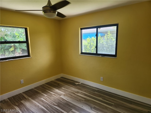 unfurnished room with ceiling fan and dark hardwood / wood-style flooring