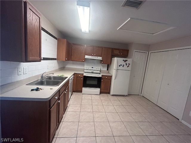 kitchen featuring light tile patterned flooring, white appliances, sink, and backsplash