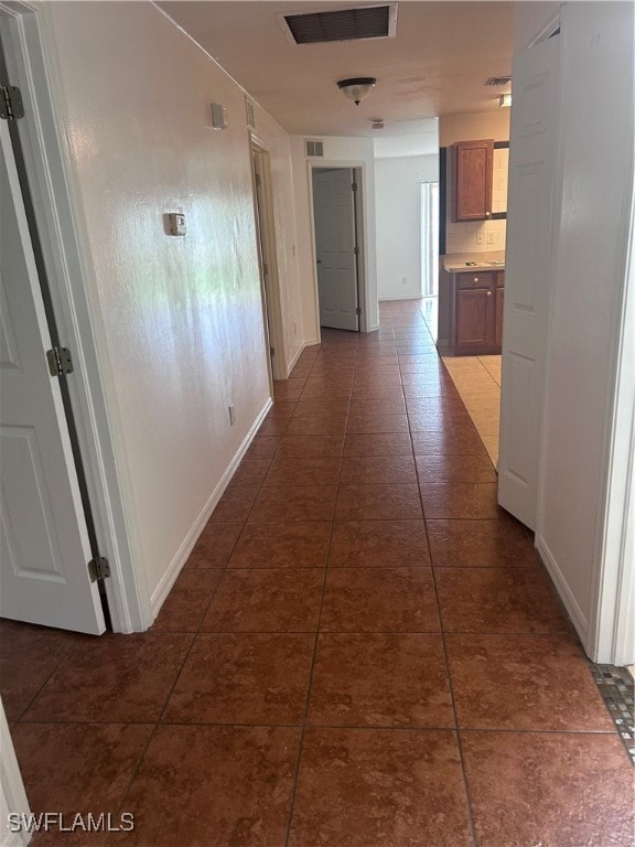 corridor with dark tile patterned floors