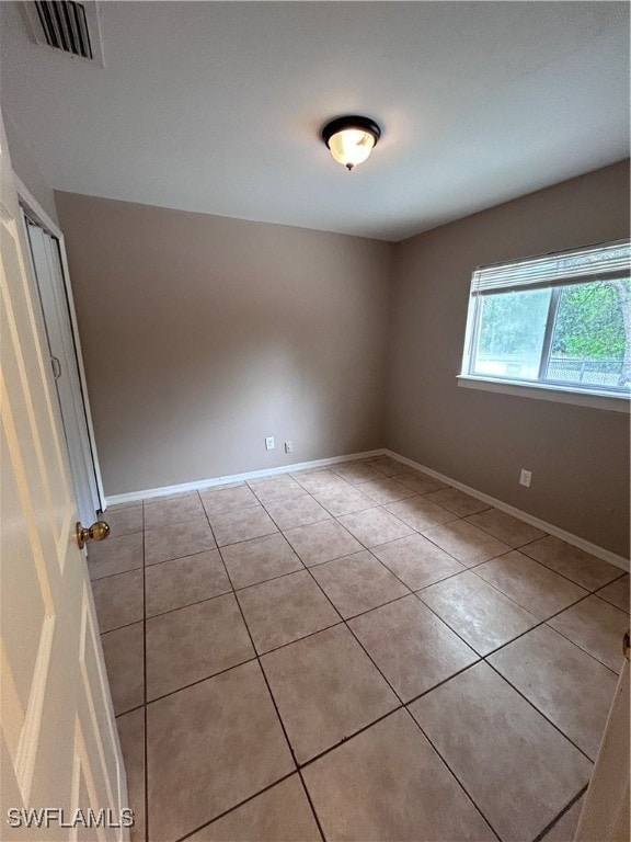 unfurnished room with light tile patterned floors