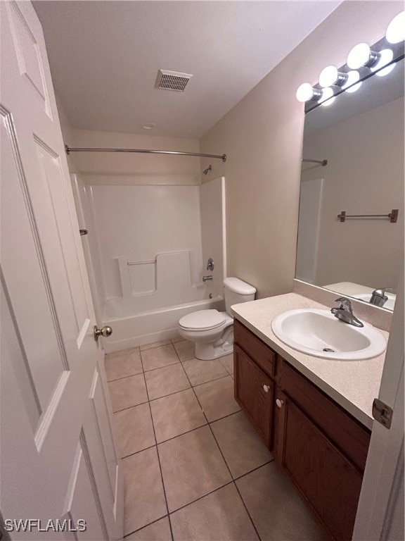 full bathroom with shower / tub combination, tile patterned floors, vanity, and toilet