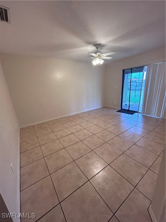 tiled empty room with ceiling fan