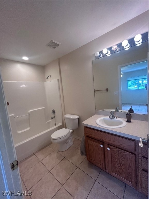 full bathroom featuring toilet, tile patterned floors, vanity, and bathing tub / shower combination