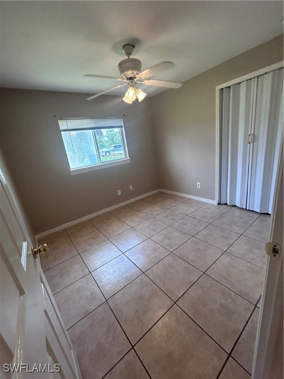 unfurnished bedroom featuring ceiling fan and light tile patterned floors