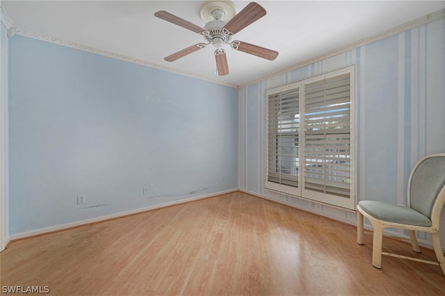 unfurnished room featuring ceiling fan, light wood-type flooring, and ornamental molding