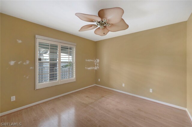 empty room featuring ceiling fan and hardwood / wood-style flooring