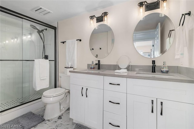 bathroom with vanity, toilet, and a shower with door