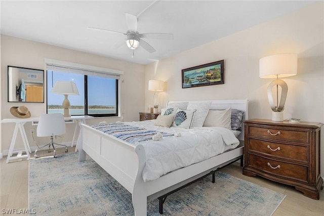 bedroom with light wood-type flooring and ceiling fan