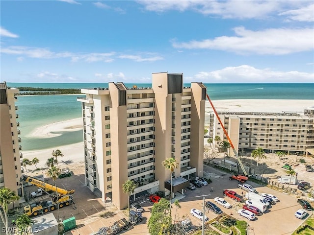 aerial view with a water view and a beach view