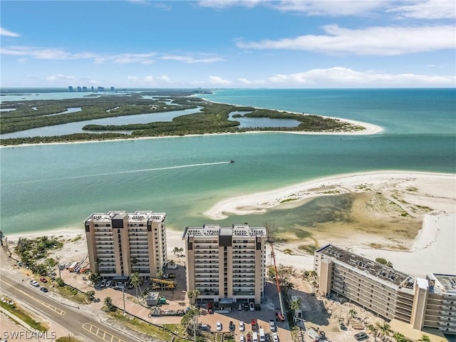 birds eye view of property with a water view and a view of the beach