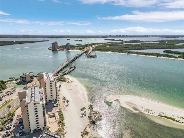 birds eye view of property with a water view and a beach view